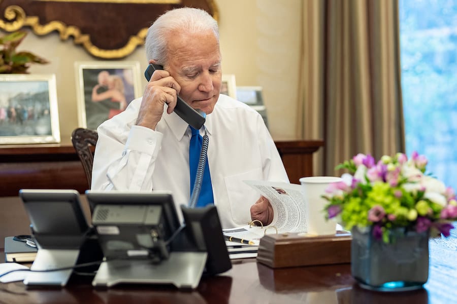 President Joe Biden talks on the phone with January 6th heroes, Thursday, January 6, 2022, in the Oval Office Dining Room of
