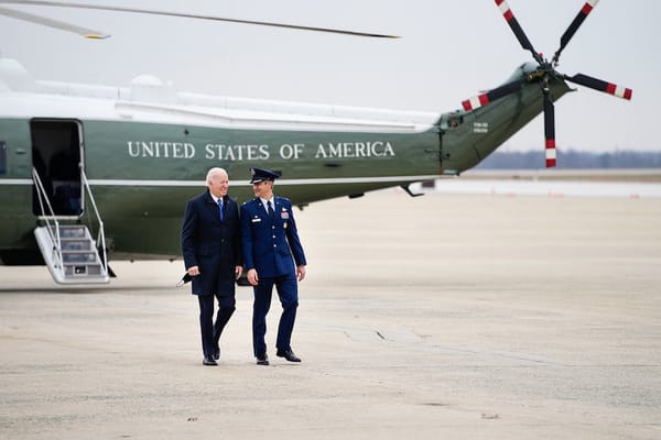 President Joe Biden disembarks Marine One Wednesday, December 8, 2021, and is escorted to Air Force One by Col. Matthew Getty